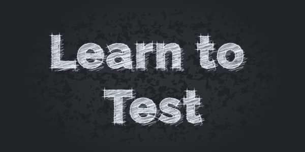 Learn To Test written on a black chalkboard